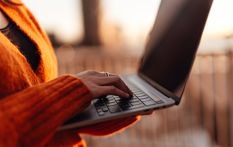 Woman is typing on her laptop